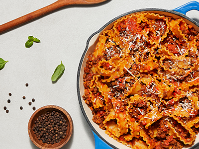 Freshly prepared pasta with meat sauce, cheese, and black pepper